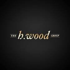 The b.wood Group logo featuring elegant gold lettering on a dark background