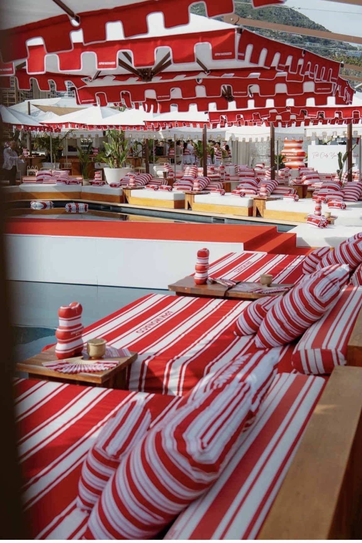 Vintage-style diner interior with red and white striped booths, curved ceiling panels, and coordinated striped table settings and decor