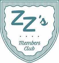 ZZs Members Club logo featuring blue lettering on a shield-shaped badge with decorative border