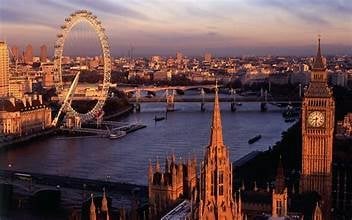London skyline at dusk featuring the London Eye, Big Ben, and River Thames with historic architecture