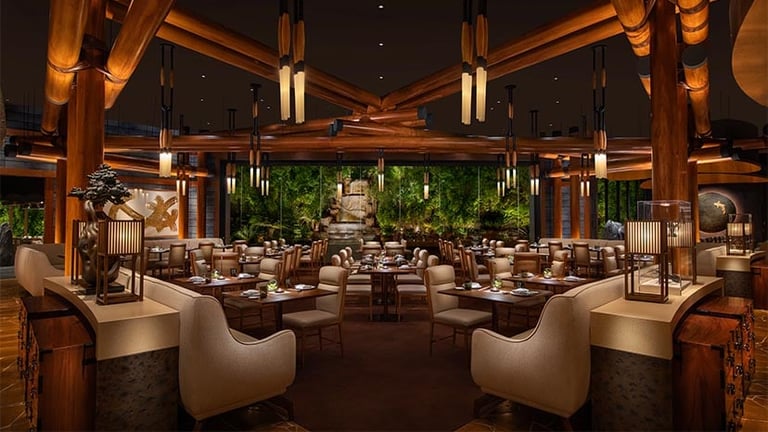 Elegant modern restaurant interior with wooden beams, ambient lighting, dining tables, and green plants throughout the space