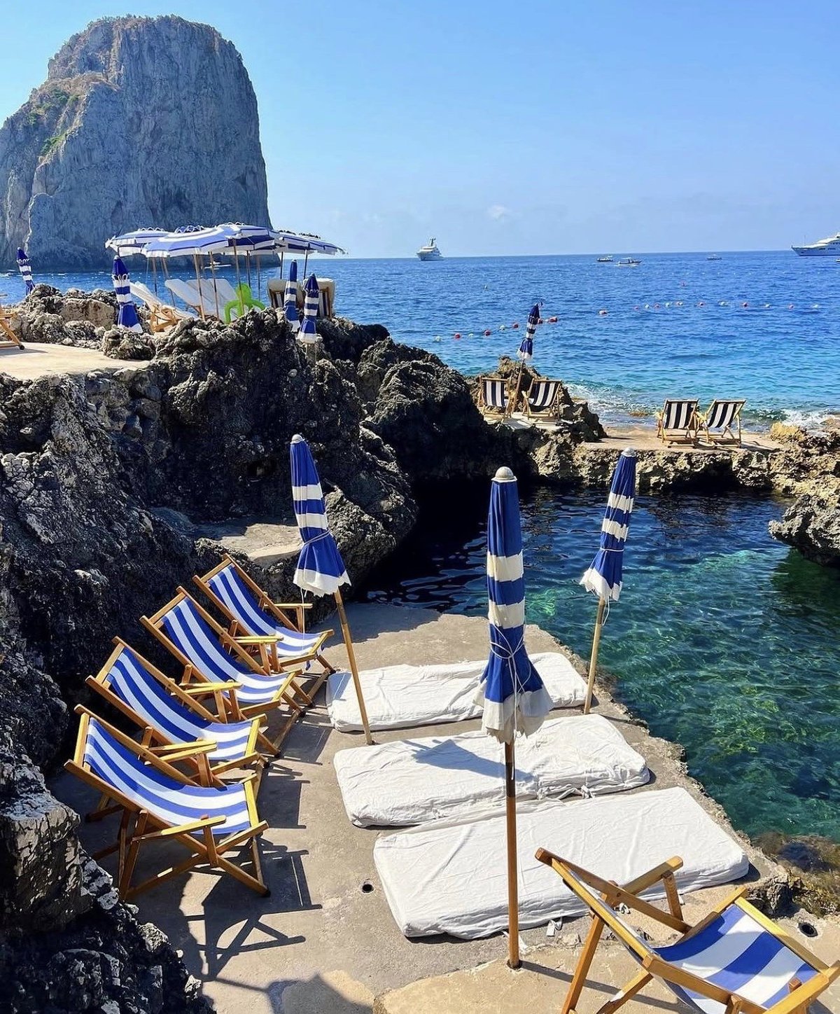 La Fontelina beach club beneath the Faraglioni rocks in Capri