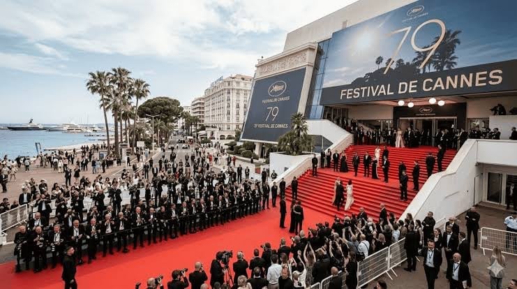 Red carpet at Cannes Film Festival 72nd edition with crowds and Mediterranean waterfront in background